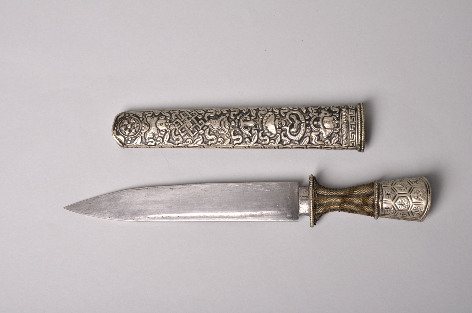 Tibetan Dagger with an Embossed Sheath: Origin: Tibet, Early 20th century Dimensions: