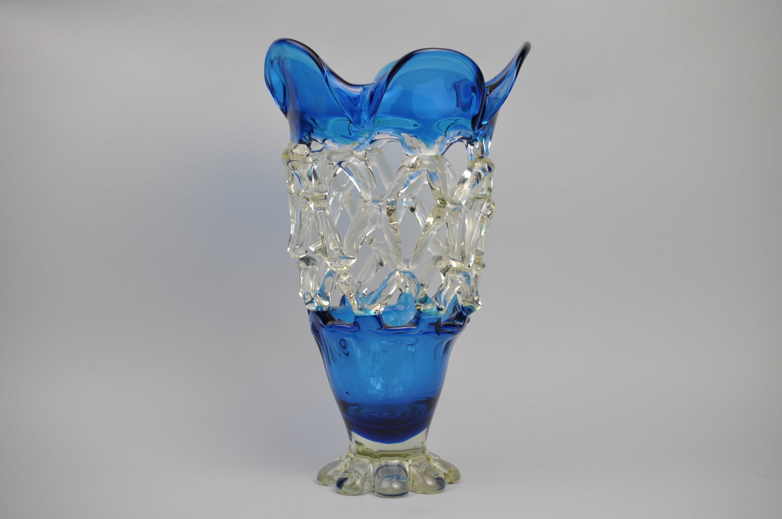 Murano Lattice Glass Vase: Dimensions: Approx 1/2x3 1/2x7" Condition: No Visible Wear Additional Information: This blue and clear Murano lattice glass vase is beautiful example of the Venetian glassmaking tradit