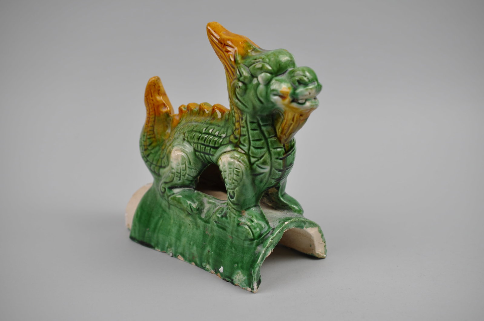 Chinese Sancai Glazed Dragon Foo/Qilin Dog 20th Century Roof Tile: Origin: China, 20th Century Dimensions: 3x7x8" Condition: Rough Spots Along the Base