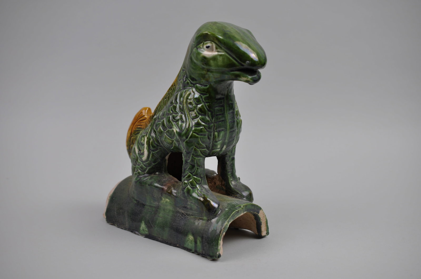 Chinese Sancai Glazed Lizard Foo/Qilin Dog 20th Century Roof Tile: Origin: China, 20th Century Dimensions: 3 1/2x8x10" Condition: Rough Spots Along the Base