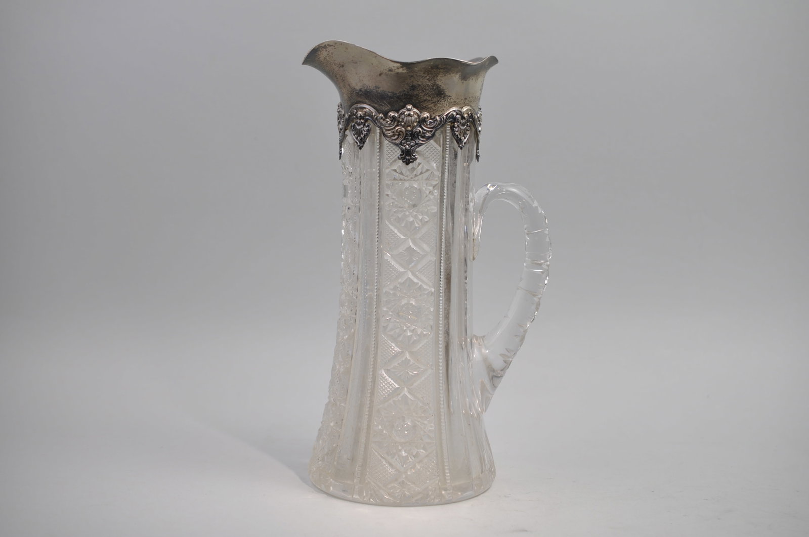 Sterling Silver and Crystal Style Glass Pitcher: Manufacturer:?Gorham Dimensions:?Approx. 5x5x12" Condition: Silver has Patina, and Pitcher Needs Cleaning