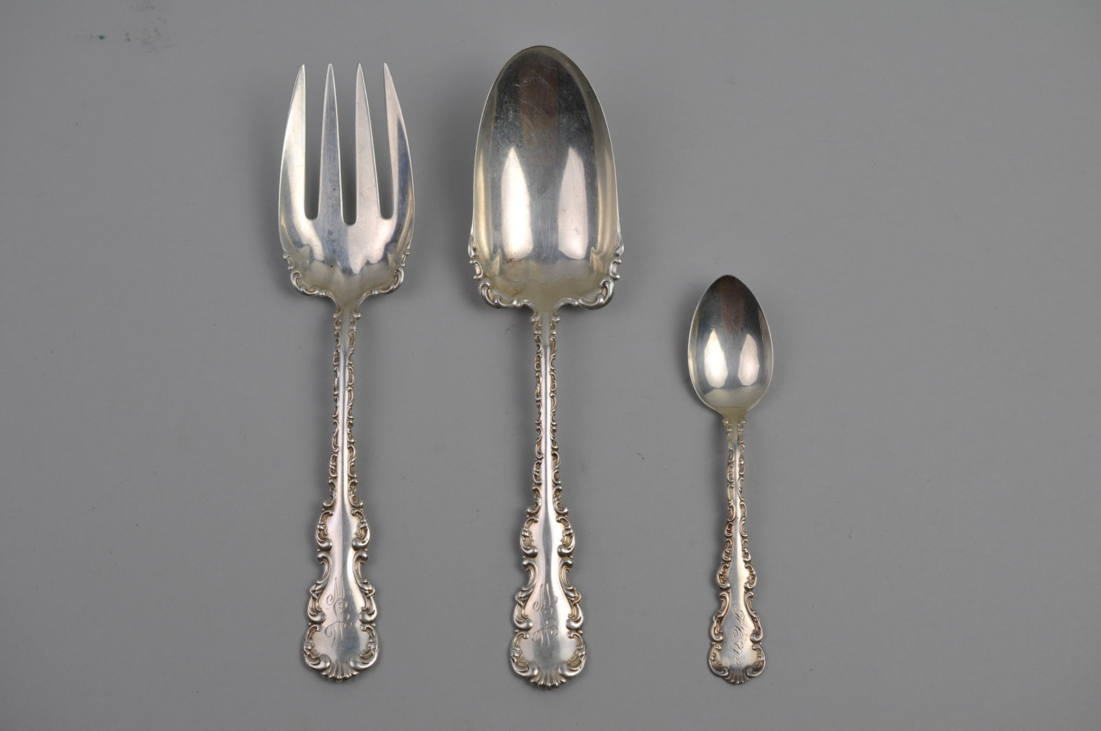 Louis XV Sterling Silver Serving Ware Set: Metal: Sterling Silver Manufacturer:?Louis XV Dimensions:?Large Serving Spoon and Fork are?9", Tea Spoon is 3/4" Weight: 5.42?ozt Condition: