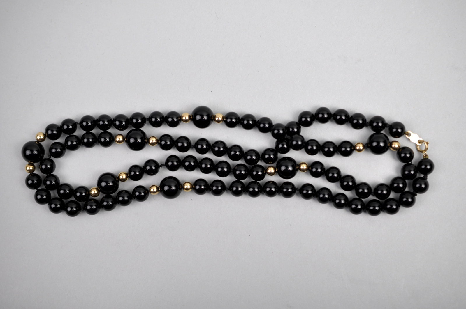 14K Gold Black Onyx Necklace: Metal:?14K Clasp Stone Types:?Black Onyx Dimensions:?Approx. 12" Clasped Weight:?Approx. 1.02ozt Condition:?No Visible Flaws Additional Information:?Necklace comprised of polished black onyx beads