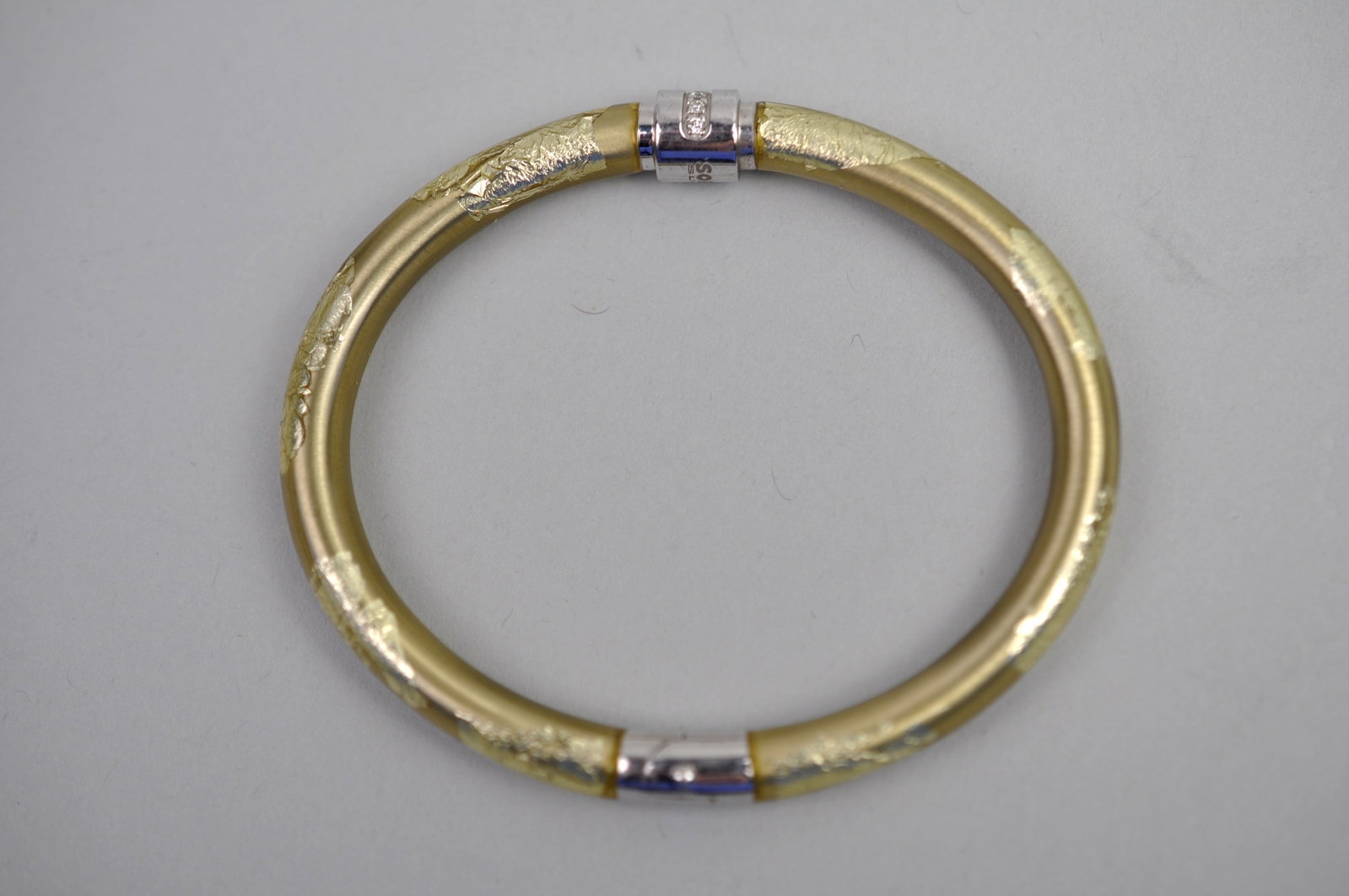Soho Silver/Gold Filled Bracelet: Metal:?Sterling Silver /12 Gold Filled Stone Types:?Diamond Dimensions: Approx. 1/4x2 3/4" Weight:?Approx .44 ozt Condition: No Visible Flaws Additional Information:?Soho Silver hinged bangle