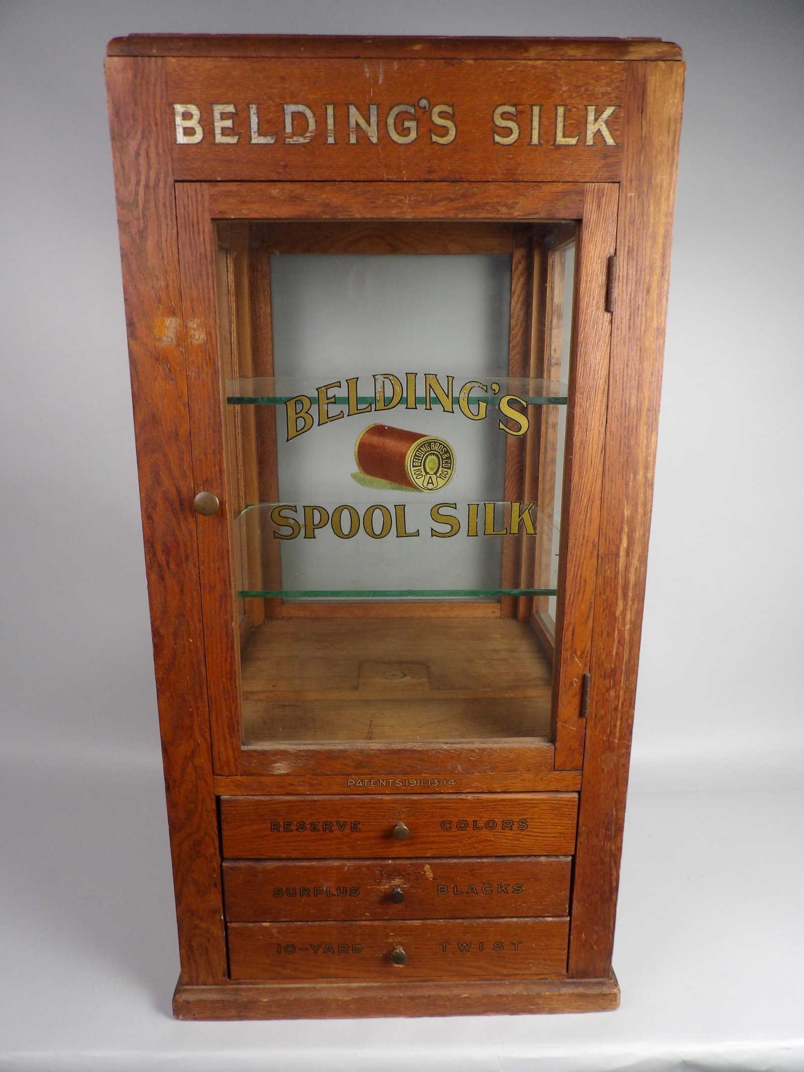 Belding Silk Display Box: Dimensions: Approx 16x16x32 1/2" Condition:? Glass Shelf Cracked on Corner. Dents, Scratches, and Marks Consistent to Daily Storefront Use. Additional Information:?Belding Silk Departm