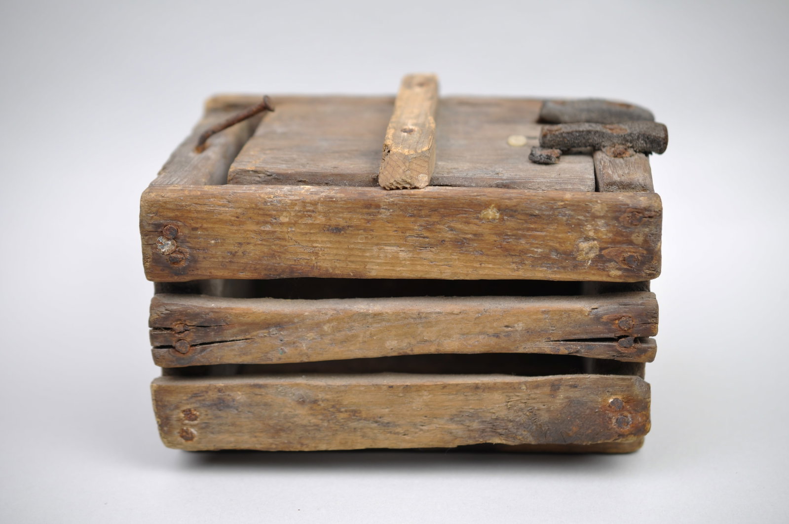 Primitive Cricket Box: Manufacturer: Handmade Dimensions: Approx 3/8x4 3/8x4 1/2" Condition: Rusting to Nail Heads, Denting/Splitting/Cracking to the Wood Additional Information: This
