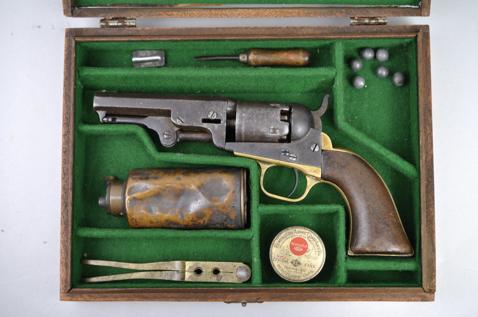 Colt Model 1849 Pocket Revolver, Case, Bullet Kit: Manufacturer: Colt Dimensions: Box with Everything Included: 10x7 1/2x2" Condition: Chamber is Pitted, Dinged, and Jammed. Wooden Pistol Grips have Dent; Right Wooden Pistol Grip has 1