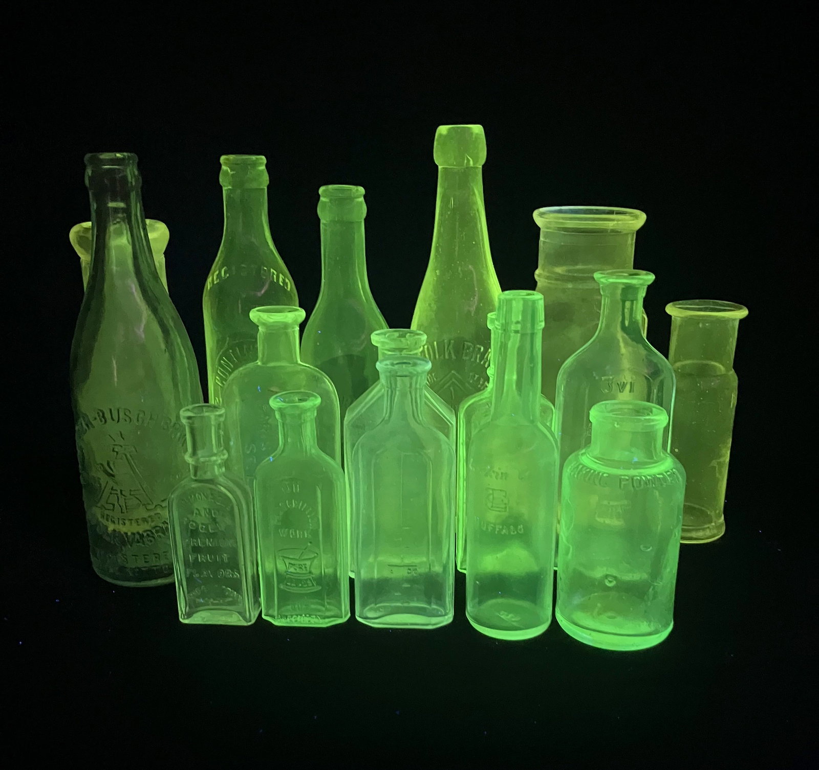 Uranium Glass Bottles: Manufacturer: Various Dimensions: Various Condition: Various Additional Information: A collection of 16 antique uranium glass bottles in a variety of small to medium sizes. These bottles are lit up