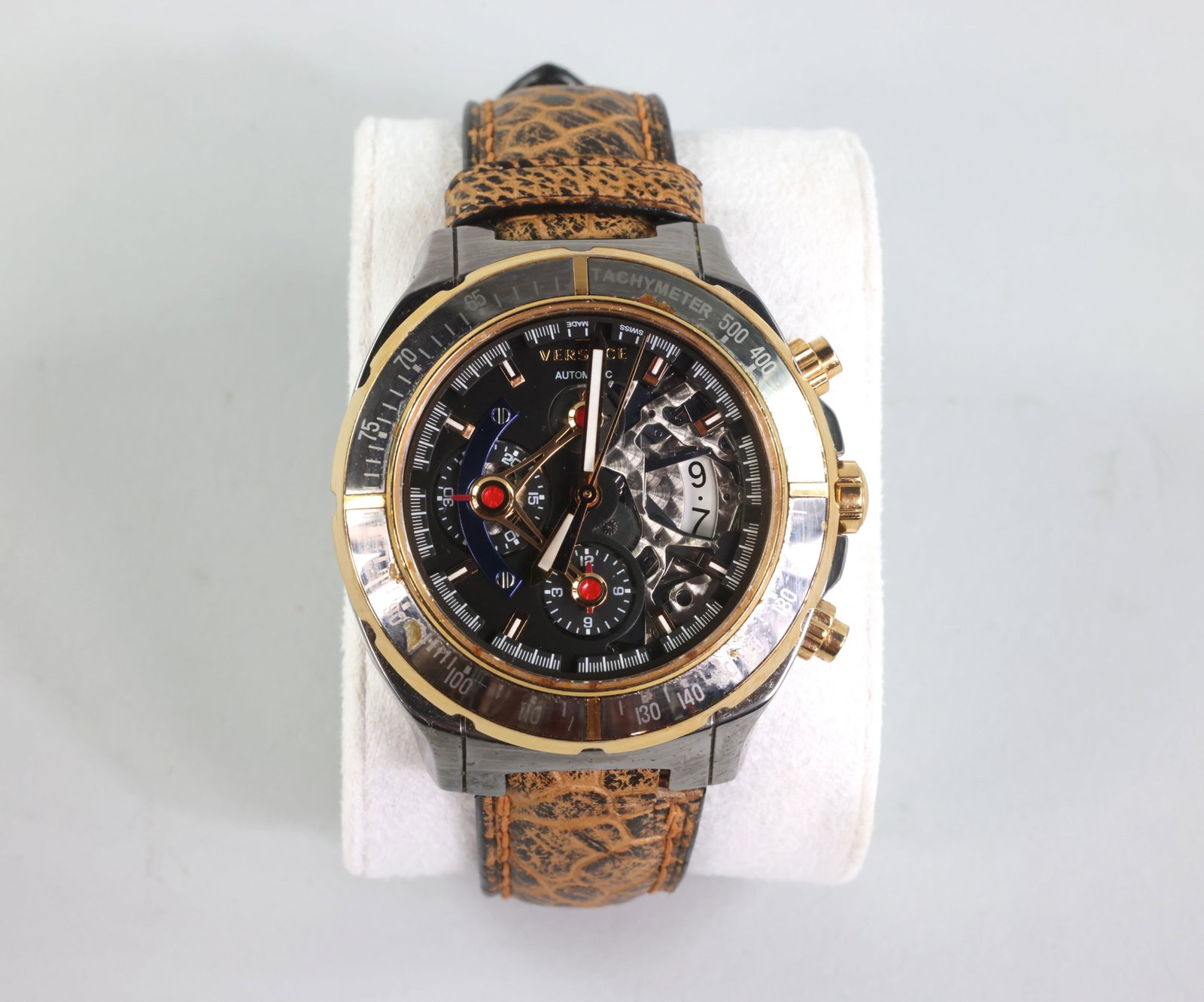 Versace DV One Skeleton Chronograph Limited Edition Watch 464/500: Brand: Versace Material: Ceramic Titanium Bezel Color: Silver and Gold Crown Type: Push and Screw Dial Material: Sapphire Crystal Movement Component: Swiss Movement Band Material: Leather Bezel