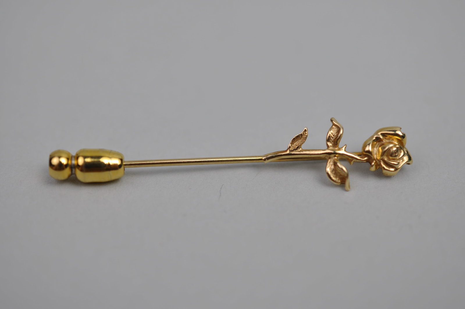 14K Gold Rose Pin: Metal: 14K Yellow Gold Stone Types: None Dimensions: Approx. 1.9 in. long