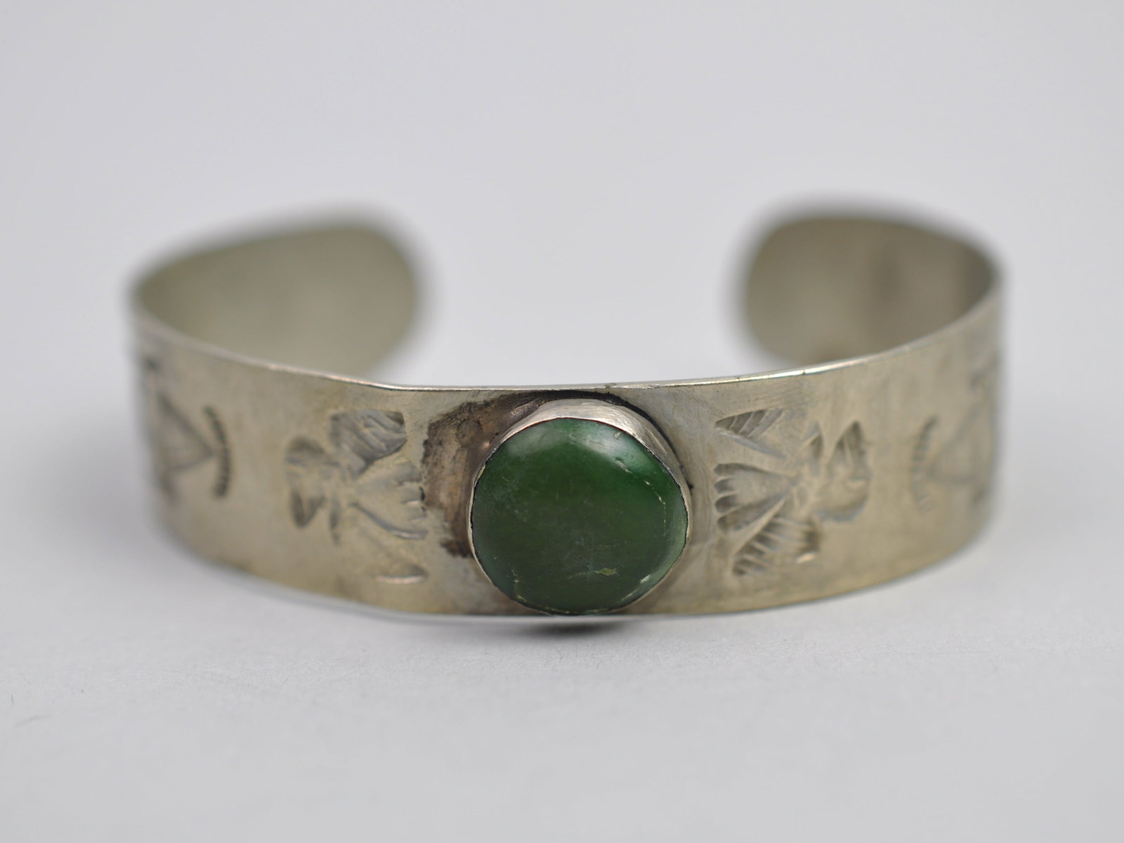 White Metal Cuff Bracelet Green Turquoise: Metal: White Metal, unmarked Stone Types: Green Turquoise or Green Hardstone Cabochon Dimensions: Approximately 2.5 in. interior diameter Weight: 0.57ozt Condition: Surface wear consistent with age