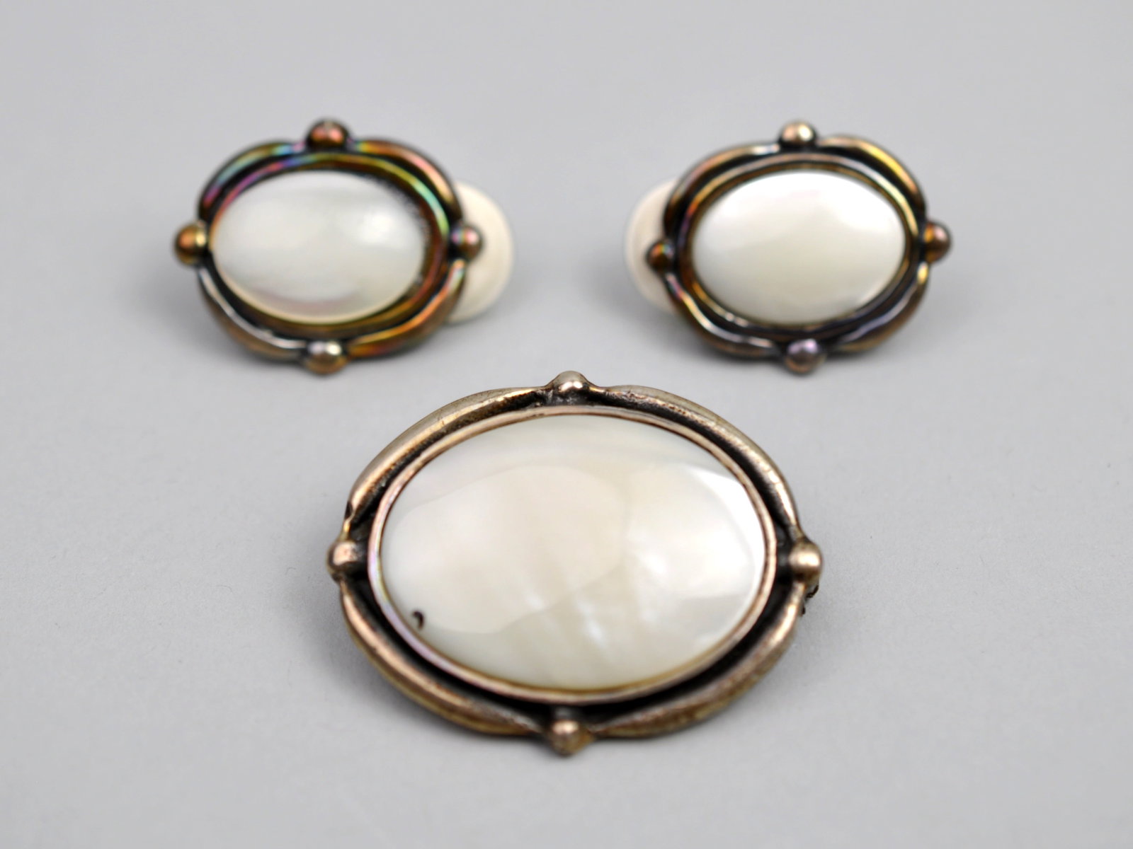 Sterling Silver Mother-of-Pearl Brooch & Earrings: Metal: Sterling Silver Stone Types: Mother-of-Pearl Cabochons Dimensions: Brooch approximately 1.5 in. x 1.25 in.; earrings approximately 0.75 in. x 0.5 in. Weight: 1.38ozt (set) Condition: Surface