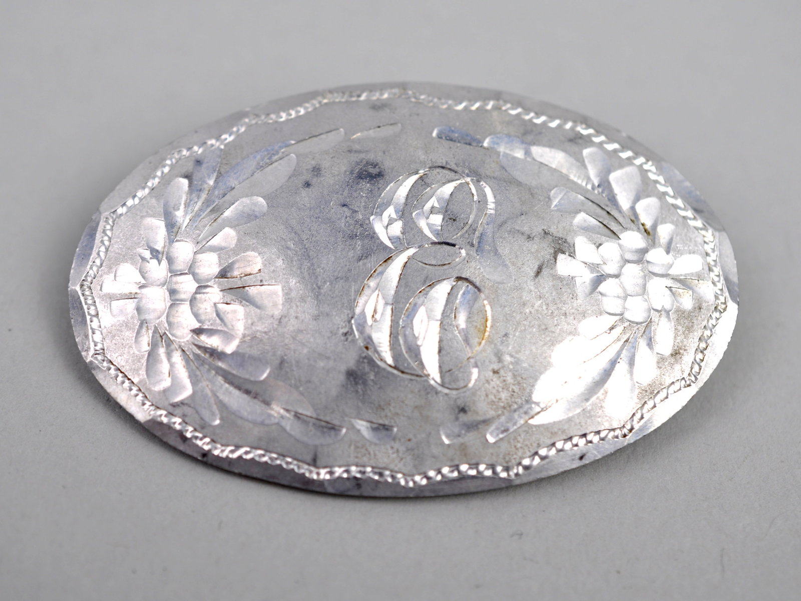 22k White Gold Brooch: Metal: Tested approximately 22K-24K Gold Stone Types: None observed Dimensions: Approximately 1.5 in. Weight: 0.27 ozt Condition: Surface wear consistent with age and use. Additional Information: