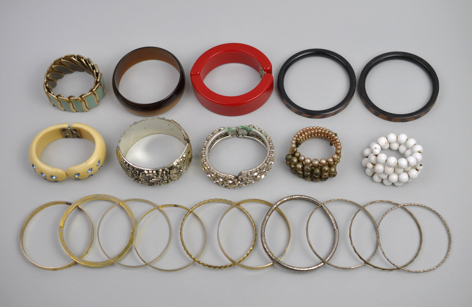 Costume Jewelry Bracelet Collection: Dimensions: Various Weight: Various Condition: Light Wear Consistent with Signs of Daily Use Additional Information: The collection consists of twenty costume jewelry bracelets crafted from a variety