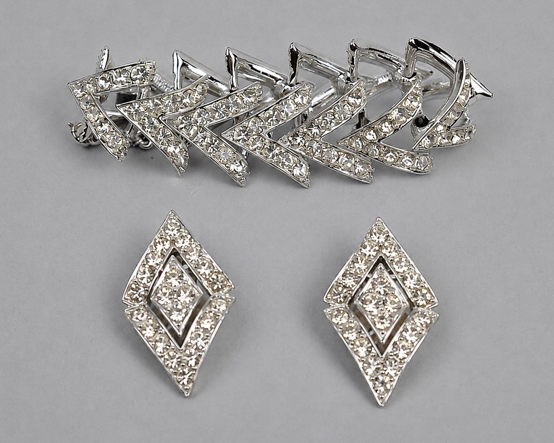 Sarah Coventry Bracelet Earrings: Metal: Silver Tone Metal Stone Types: Clear Rhinestones Dimensions: Bracelet 8.5 in.; Earrings approximately 2 in. Weight: 2.17ozt (set) Condition: Surface wear consistent with age and use.