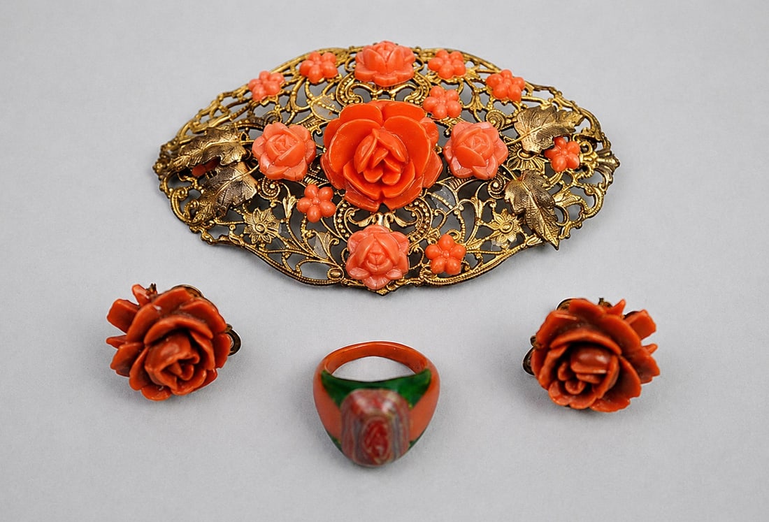Celluloid Brooch Earrings Ring: Maker: Unmarked Type: Brooch, screw back earrings, and ring Dimensions: Brooch approximately 3 in. W; ring size 3 Condition: Surface wear consistent with age and use. Minor wear and patina to metal