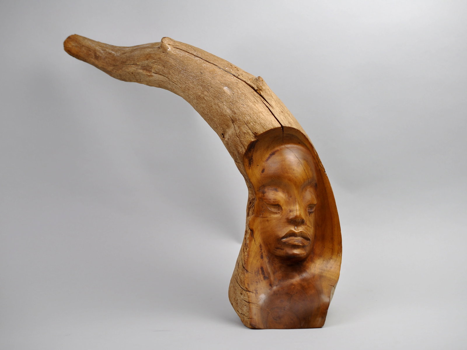 Signed Madame Pele Wooden Sculpture: Medium: Wood Origin: Hawaii Dimension: 6 1/2x5x14 3/4 in. Overall Length 26 in. Condition: No Visible Issues Additional Information: This striking Madame Pele wooden sculpture, signed by artist John