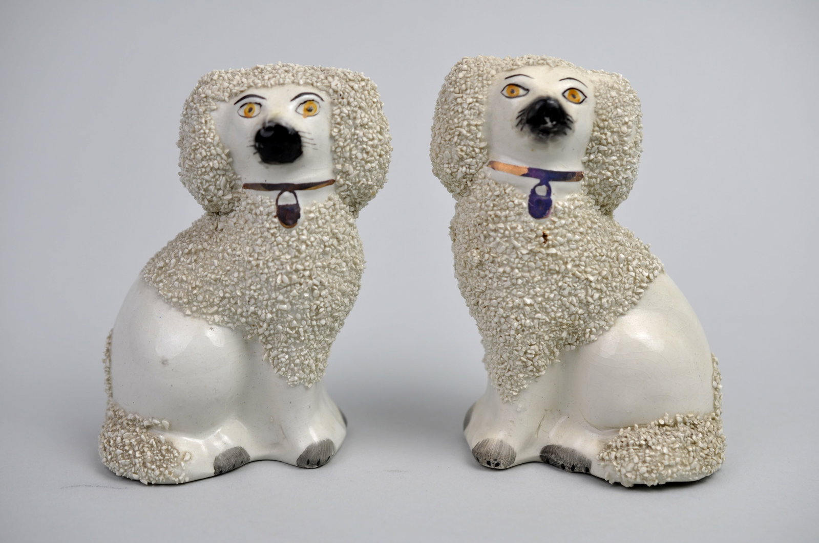 King Charles Staffordshire Spaniel Figurines: Manufacture: Staffordshire Ware Dimensions: 3x2x4 3/4 in. Condition: Vent Holes on Bottom, Mild Dust and Debris Additional Information: This charming collectible set of two King Charles Staffordshire