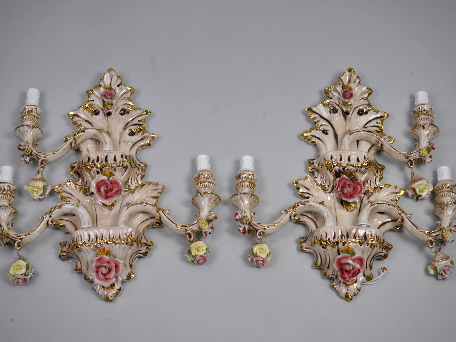 Capodimonte Sconces Three Arm Set: Dimensions: Approx. 19x17 in. Condition: Untested, Some Arms have Repairs Made to Them. May Contain Hairline Cracks and Small Chips Additional Information: A set of three-armed Capodimonte chandelier