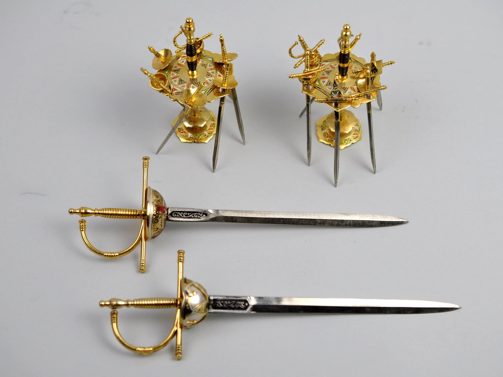 Cocktail Sword Sets and Letter Opener Swords: Manufacturer: Toledo Dimensions: Various Condition: Light Scratches from Use Additional Information: This collection of Toledo sword-themed accessories includes two cocktail sword sets and two