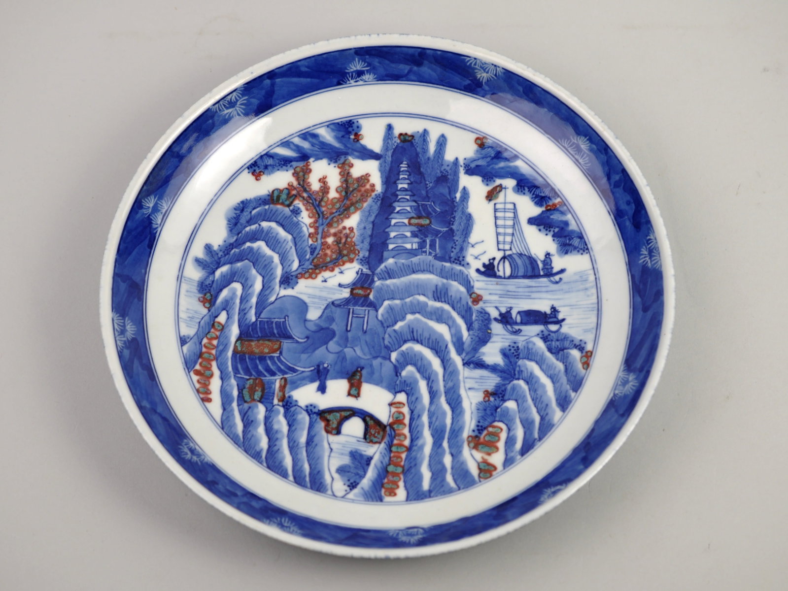 Chinoiserie Plate 19th Century: Manufacturer: Marking Reads, "Made during the Kangxi Reign of the Great Qing Dynasty" Dimensions: 9 7/8 in. Condition: Light Discoloration on Base that Touches the Surface Additional Information: