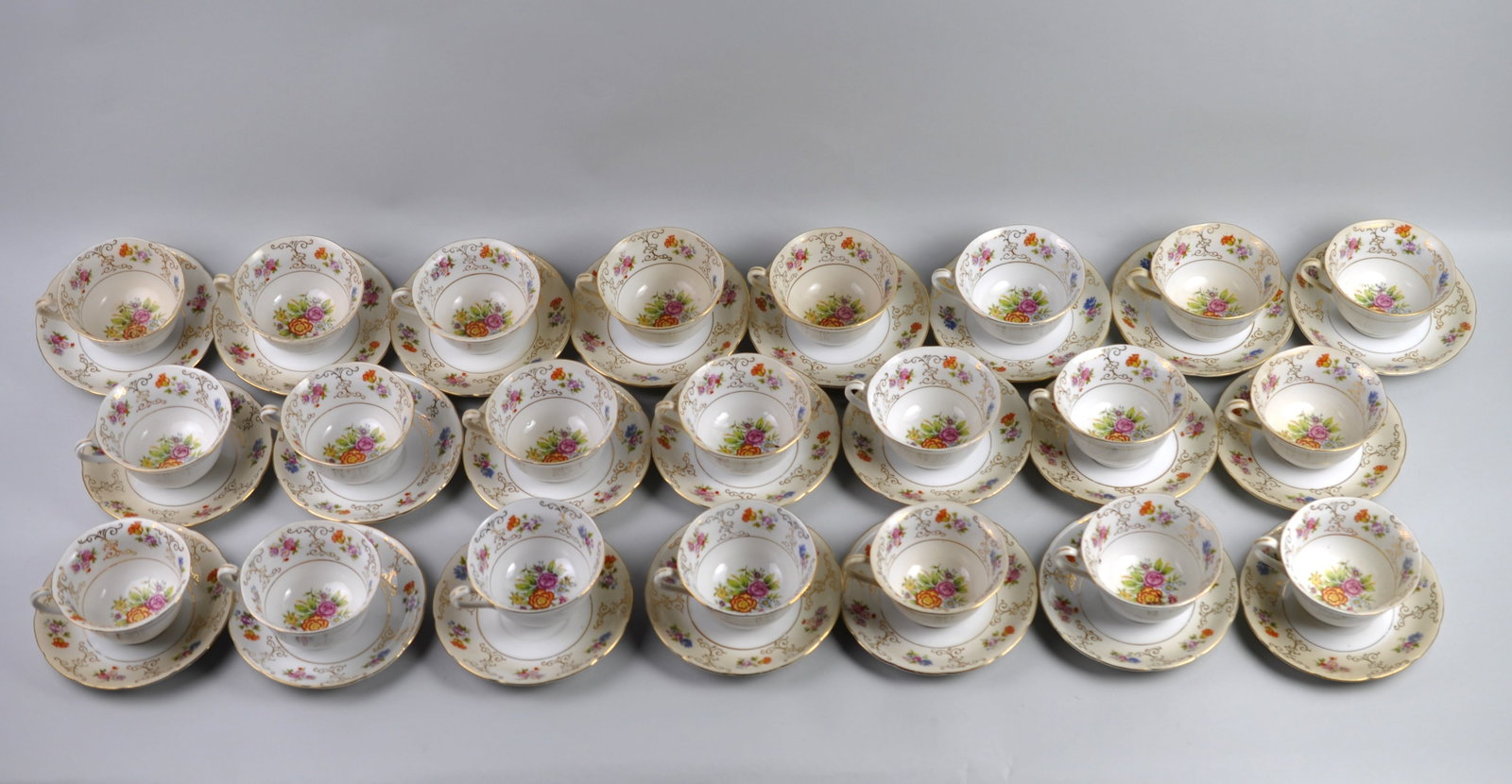 Chikaramachi China Teacups & Saucers: Manufacturer: Chikaramachi Dimensions: 22 teacups 4 in. and 22 saucers 5 1/2 in. Condition: Stains and Small Cracks and Chips Additional Information: Chikaramachi Hand Painted China Teacup Set