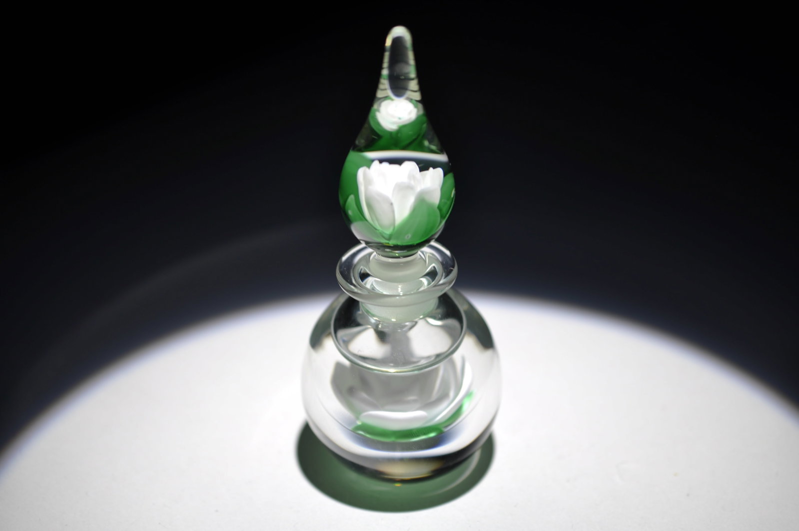 Whittemore White Rose Fragrance Bottle: Attributed Brand: Francis Whittemore Period: 1974 Style: Motif, Perfume Bottle, Lampwork Base: Clear Measures: 4.25 in. Weight: 0.38 lb Condition: Base Wear. Additional Information: A central
