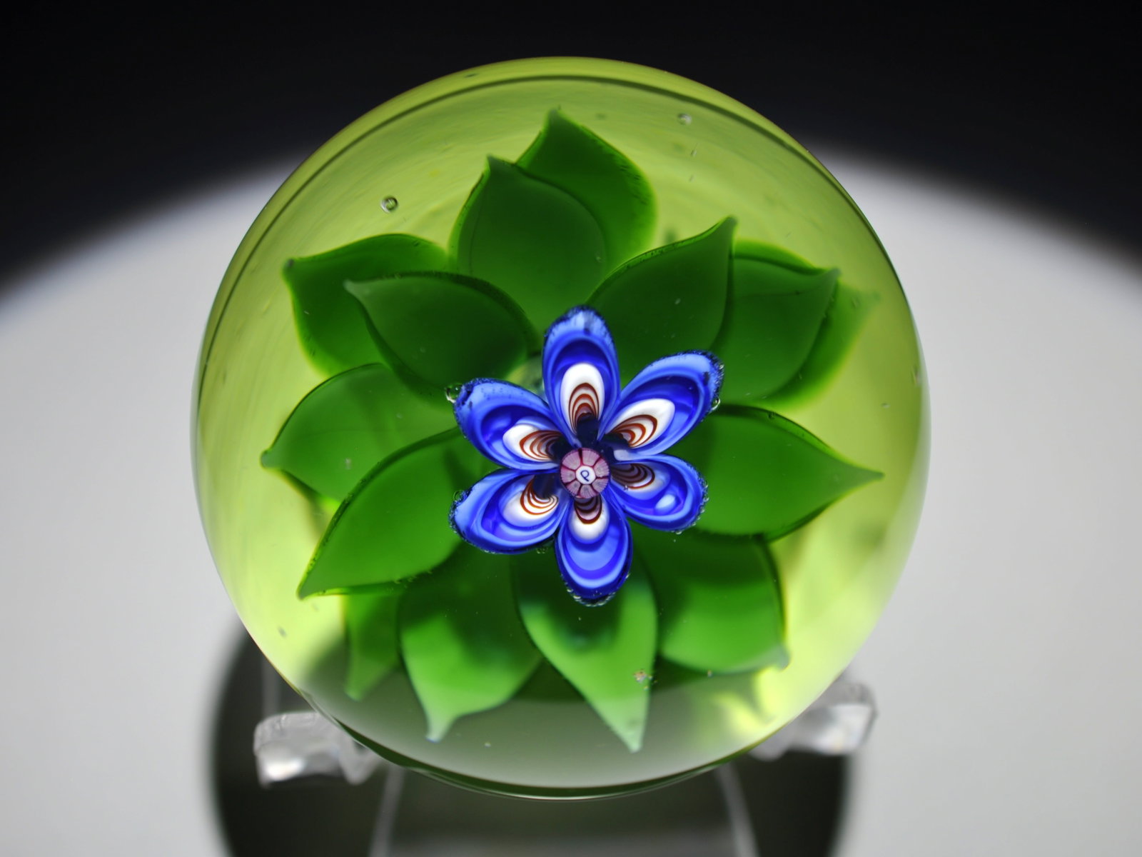 1980 Perthshire Lampwork Flower: Attributed Brand: Perthshire, Crieff Scotland Period: 1980 Style: Motif, Ground, Millefiori, Signature Cane Base: Clear Diameter: 2.45 in. Weight: 0.92 lb Condition: Base wear Additional Information: