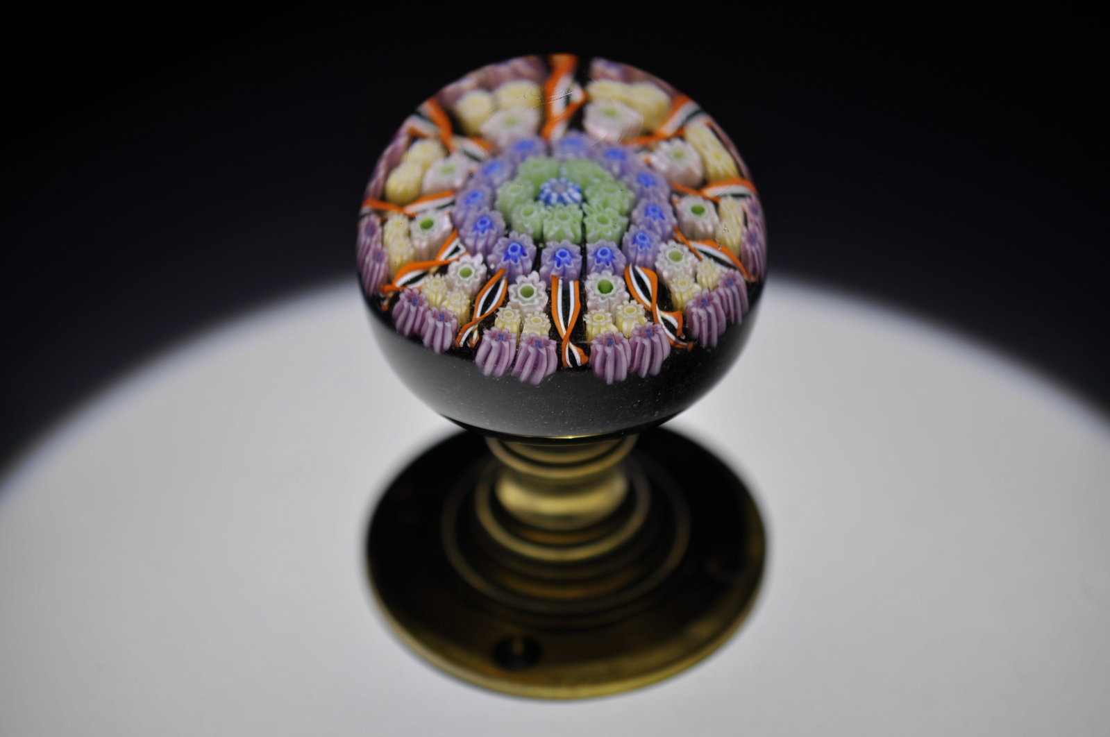Perthshire 1981 Millefiori Glass Doorknob: Attributed Brand: Perthshire Period: 1981 Style: Millefiori, Doorknob Base: Brass Pedestal Measures: 3 in. Weight: 0.89 lb Condition: Petina on Metal. Additional Information: A central complex cane