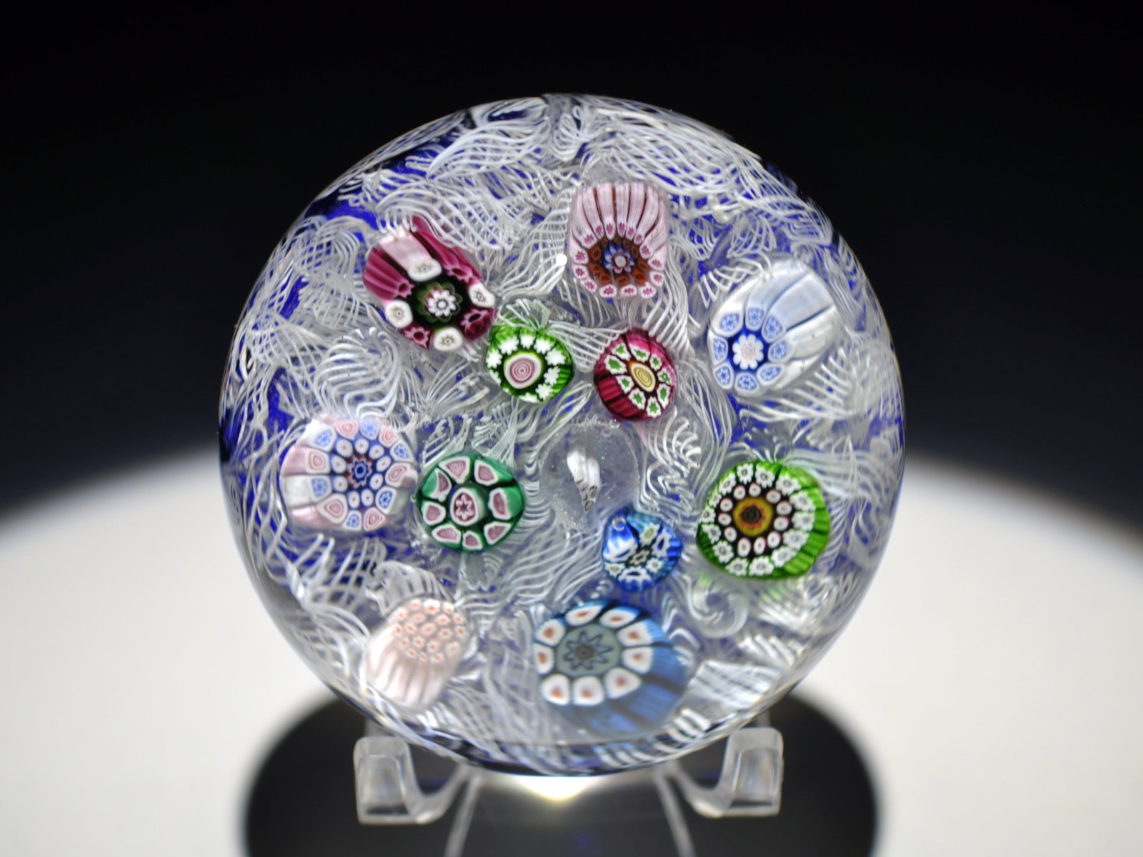 Perthshire 1970 Millefiori Paperweight: Attributed Brand: Perthshire, Crieff Scotland Style: Millefiore, Latticinio, Upset Muslin Base: Clear Diameter: 2.65 in. Weight: 0.83 lb Condition: No obvious flaws Additional Information: A blue
