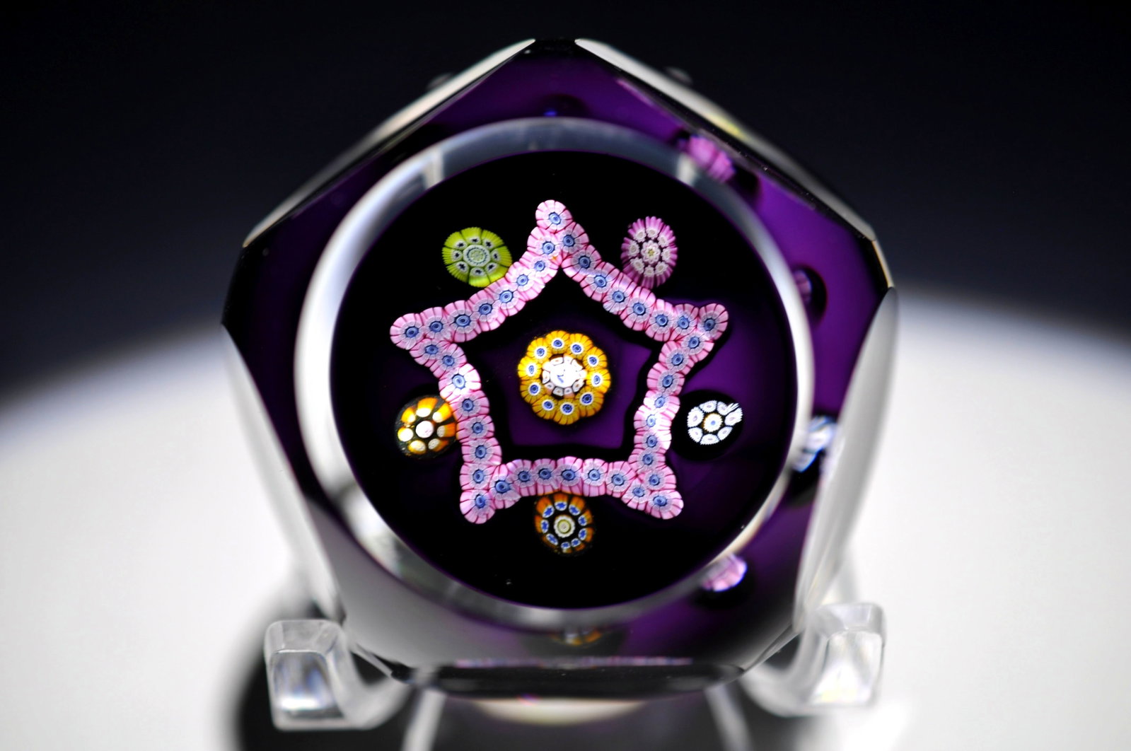Perthshire 1981 Faceted Millefiori Star: Attributed Brand: Perthshire, Crieff Scotland Period: 1981 Style: Signature Cane, Millefiori, Ground Base: Clear Diameter: 1.71 in. Weight: 0.25 lb Condition: Base Wear. Additional Information: A