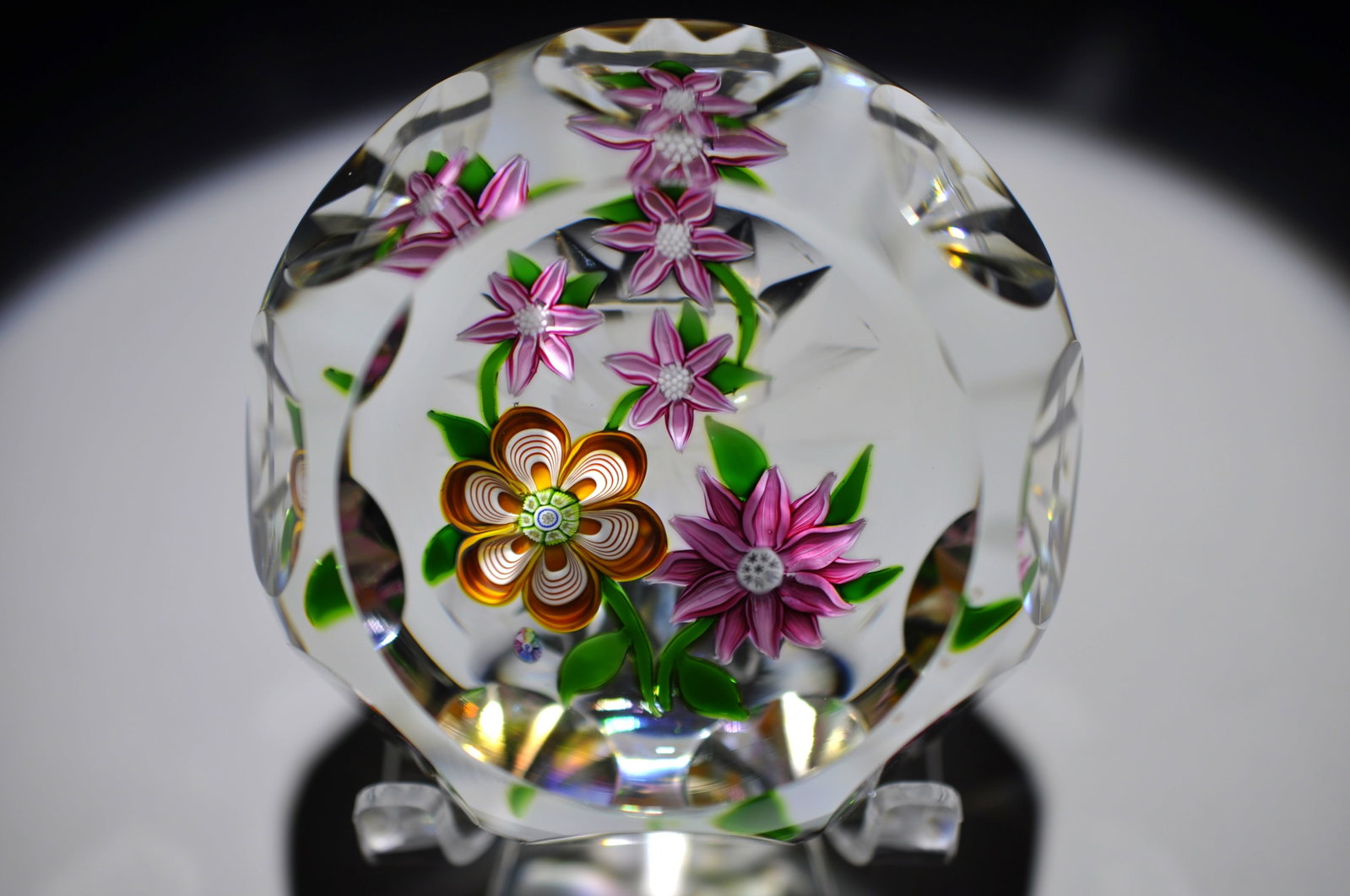 Perthshire Faceted Floral Paperweight: Attributed Brand: Perthshire, Crieff Scotland Period: 20th Century Style: Lampwork Base: Clear Diameter: 3.15 in. Weight: 1.14 lb Condition: No Visible Flaws Additional Information: A central