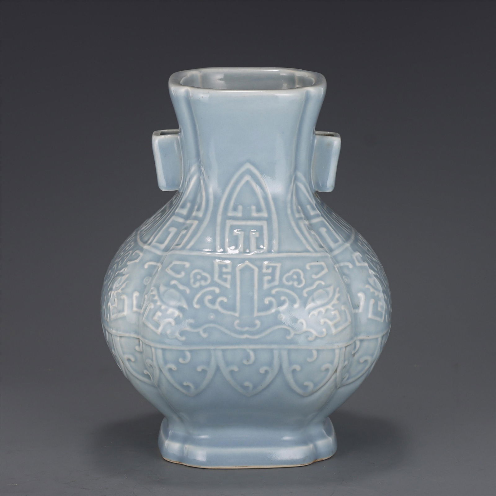 A CHINESE MONOCHROME GLAZE CARVED PORCELAIN VASE (1 of 10)
