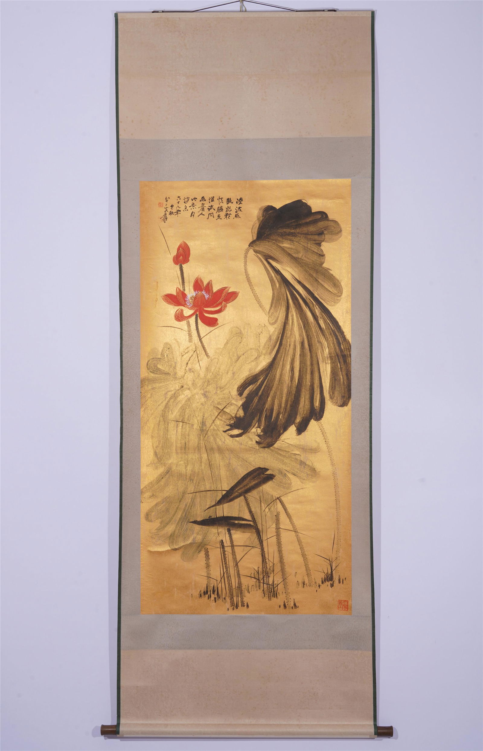 A CHINESE SCROLL PAINTING OF LOTUS ON GOLDEN PAPER: Image only size 133 cm by 65 cm.