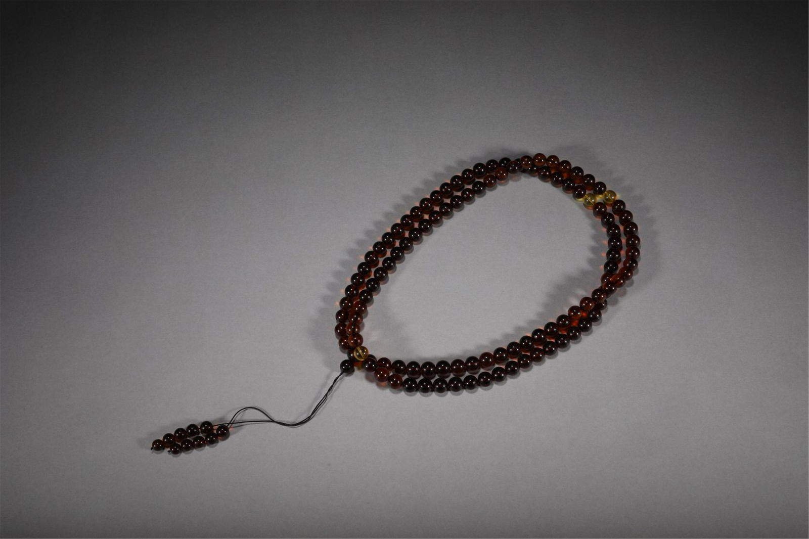 A CHINESE AMBER BUDDHIST BEADS (1 of 9)