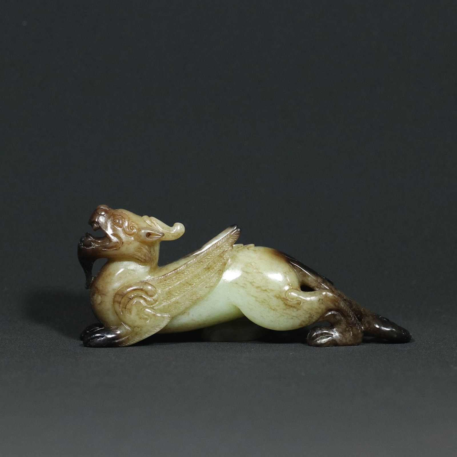 A Chinese Carved Jade Foo-Dog: Lg. 10.5cm, Ht. 4.5cm, Wt. 109