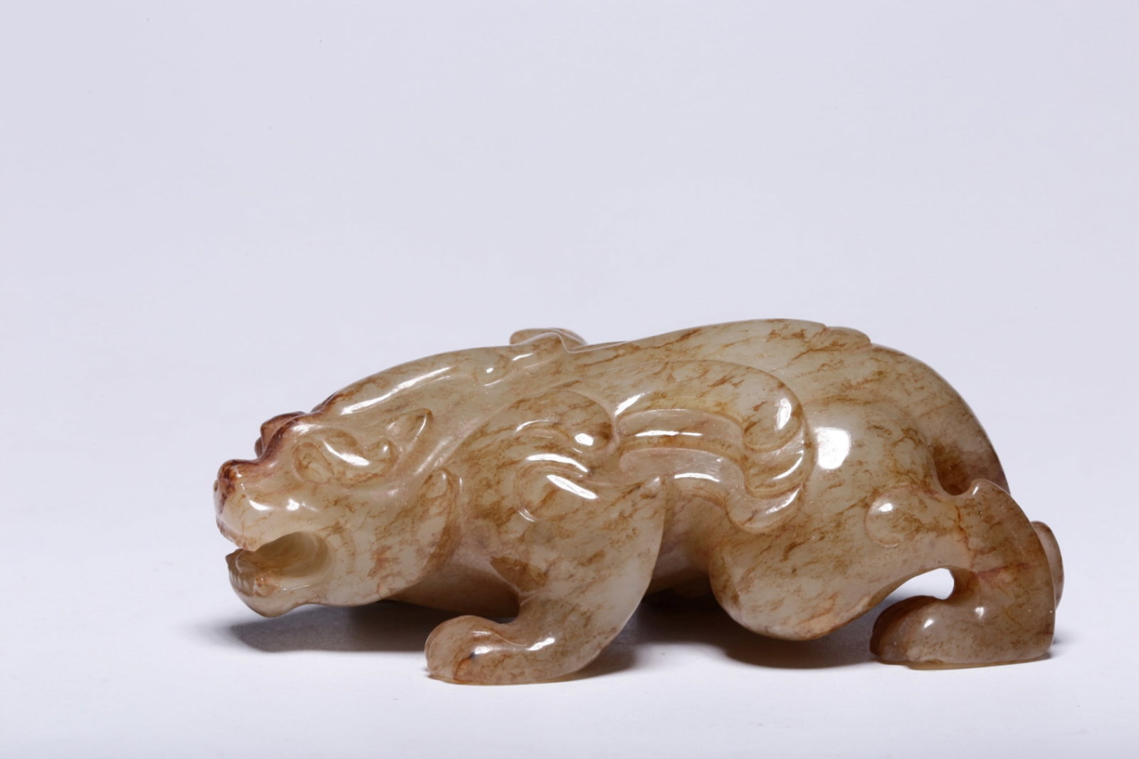 A Chinese Carved Jade Foo-Dog: Lg. 8.5cm, Wd. 4.6cm, Th. 3cm, Wt. 141g