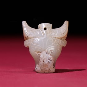 A Chinese Carved Jade Bull Head Pendant