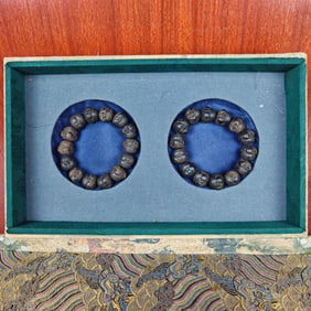 A Pair of Chinese Carved Agar-Wood Buddha Top Bracelets