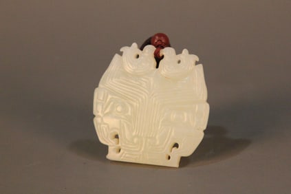 A Chinese Carved Jade Foo-Dog Pendant
