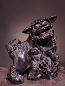 A Chinese Carved Hardwood Foo-Dog Statuette