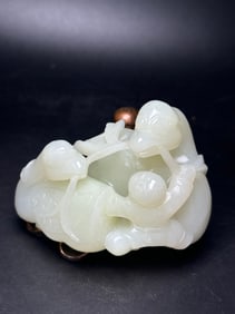 A Chinese Carved Jade Gooses and Boy Statuette