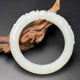 A Chinese Carved Jade Double-Dragon Bangle