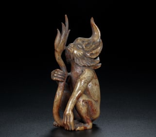 A Chinese Carved Jade Foo-Dog Statuette