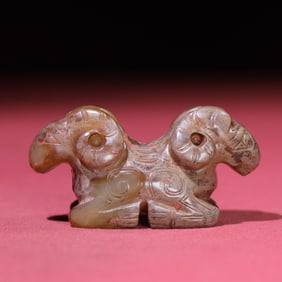 A Chinese Carved Jade Double-Goat-Head Statuette