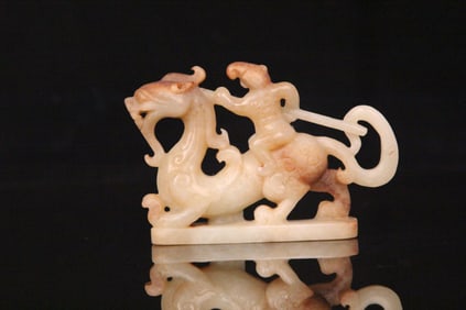 A Chinese Carved Jade Foo-Dog with Rider Statuette