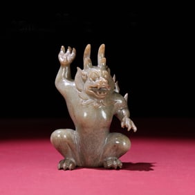 A Chinese Carved Jade Foo-Dog Statuette