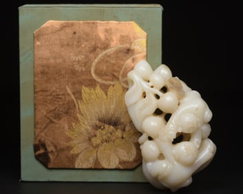 A Chinese Carved Jade Boys and Peaches Statuette