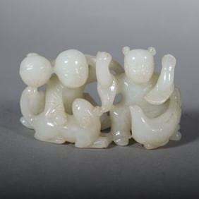 A Chinese Carved Jade Boy, Girl and Foo-Dog Statuette