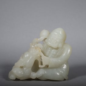 A Chinese Carved Jade Figure of Buddha and Foo-Dog